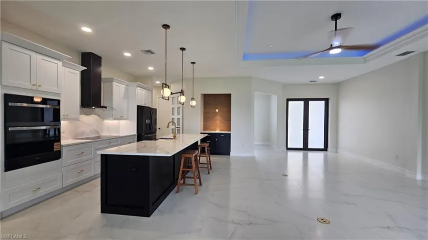 Great room and kitchen featuring the coffee bar and a microwave-oven combo