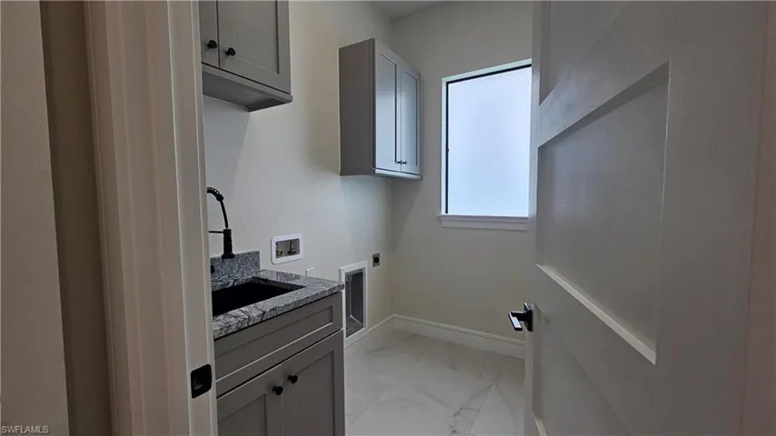 Laundry and mudroom with cabinet space and hookup for a washer and dryer