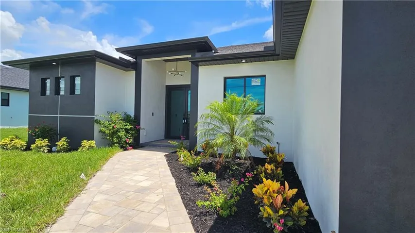 Doorway to property with stucco siding
