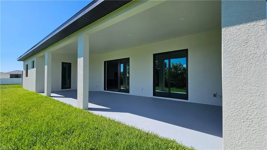 Rear view of house featuring two sliding doors and the guest bathroom access door