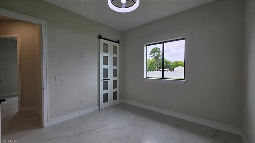 Spare room # 1 featuring barn closet door