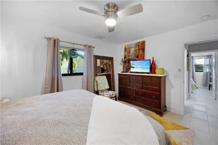 Bedroom featuring a ceiling fan and light tile patterned flooring