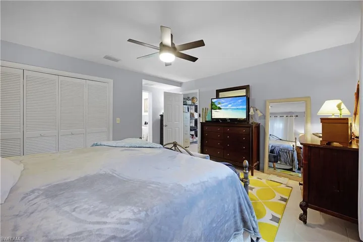 Tiled bedroom featuring a closet and a ceiling fan