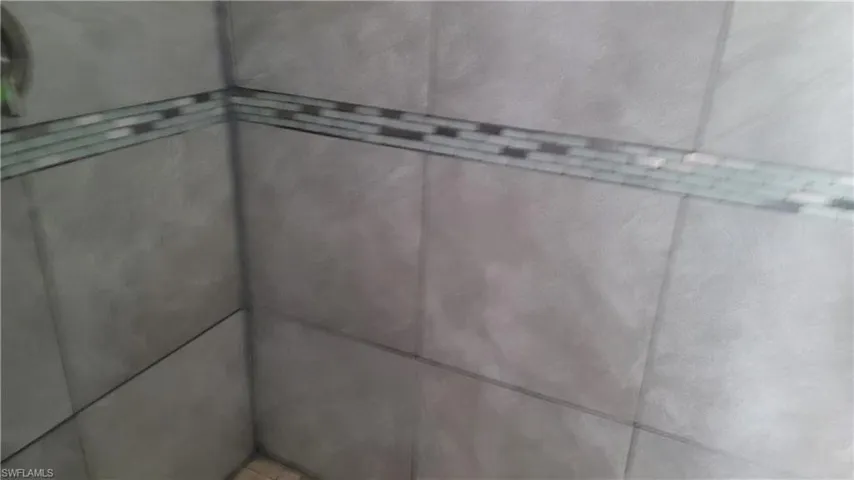 Bathroom view of elevator and tiled shower