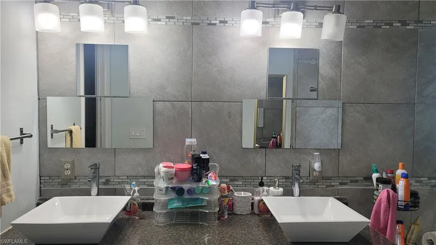 Full bath with tasteful backsplash and double vanity