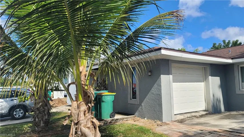 View of side of home with stucco siding and an attached garage