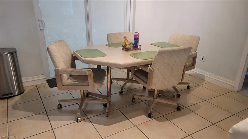 Dining space featuring baseboards and light tile patterned flooring