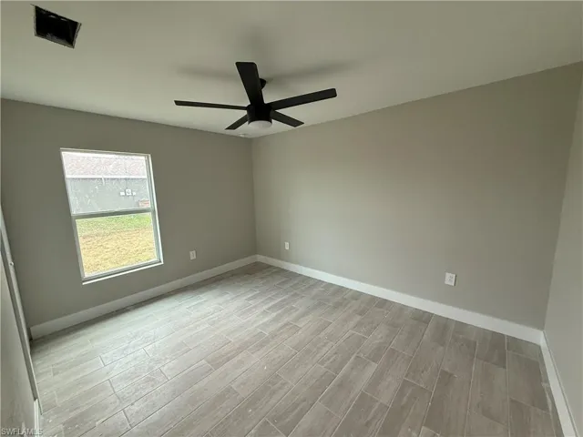 Spare room with ceiling fan and light hardwood / wood-style flooring