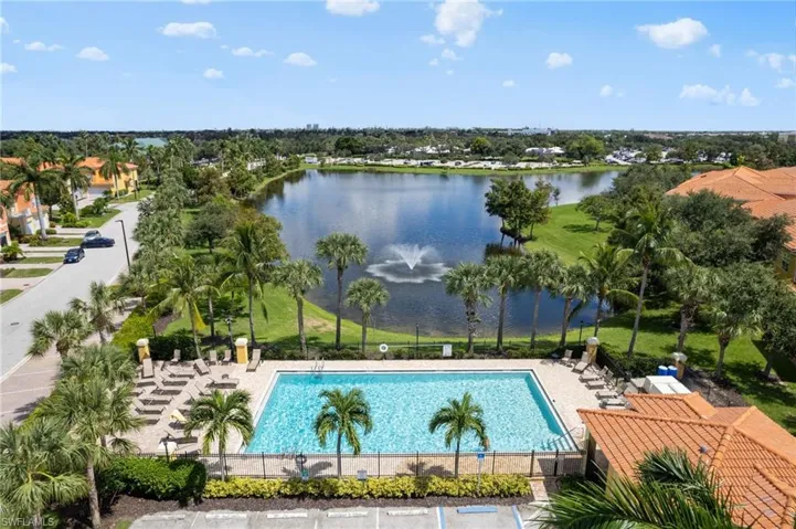 View of swimming pool with a patio and a water view