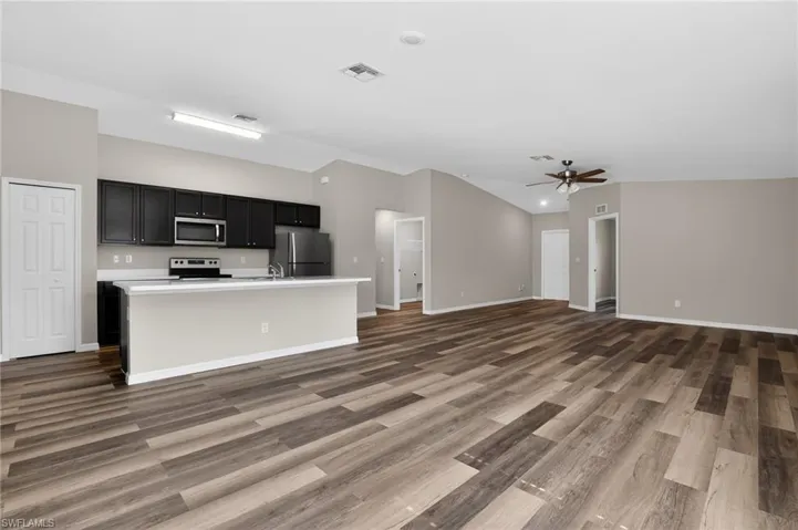 Open concept living space featuring wood-finish flooring
