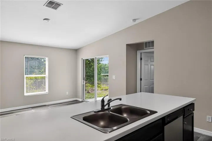 Kitchen island with a double basin sink and a matte black faucet