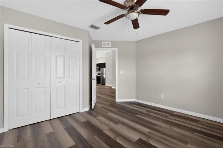 Interior room featuring wood-finish flooring and a ceiling fan