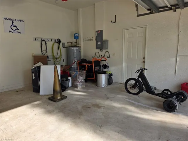 Garage with water heater and electric panel