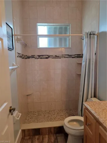 Bathroom featuring vanity and a shower stall