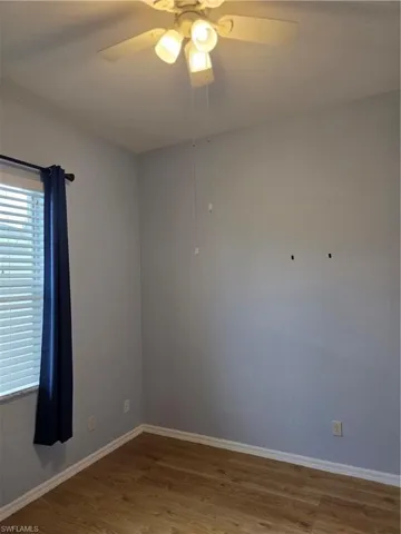 Empty room featuring wood finished floors and ceiling fan