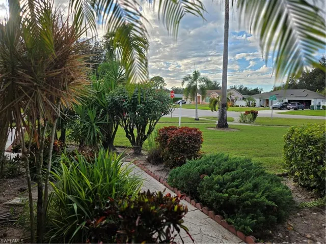 Surrounding community with a yard and a residential view