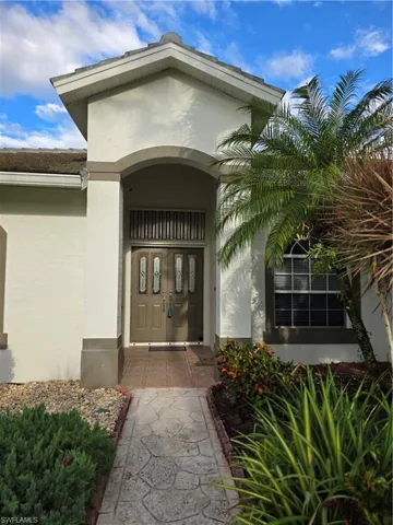 Entrance to property featuring stucco siding