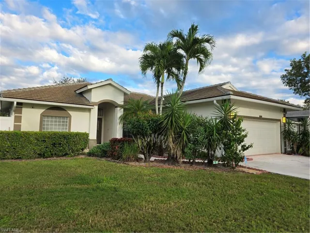 Single story home featuring a front yard, stucco siding, concrete driveway, and a garage