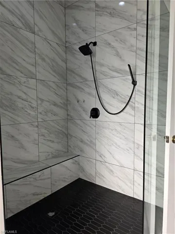 Bathroom featuring a tile shower
