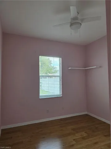 Empty room featuring wood finished floors and a ceiling fan
