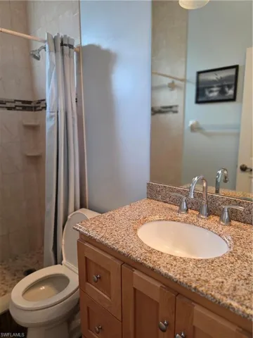 Full bath featuring vanity and a stall shower