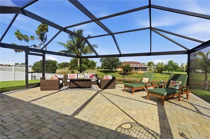 Expansive screened lanai featuring a paver patio and ample space for outdoor living