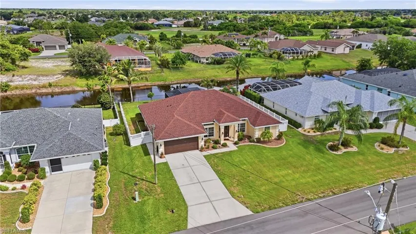 Single-story residence featuring a red tile roof and an attached two-car garage