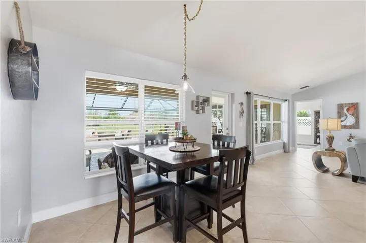 Open-concept interior featuring light gray walls, white baseboards, and neutral tile flooring