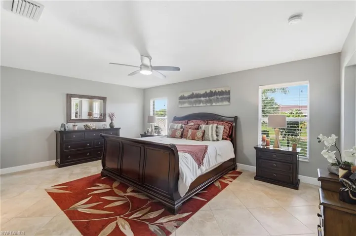 Spacious room with tile flooring, light gray walls, and multiple windows with blinds