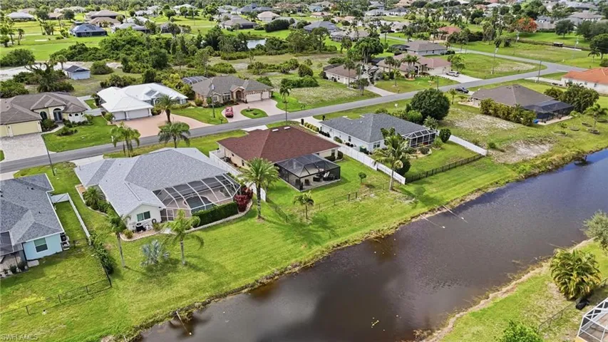 Residential neighborhood featuring canal-front properties with screened enclosures