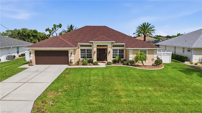 Contemporary single-story residence with a red tile roof and stucco exterior
