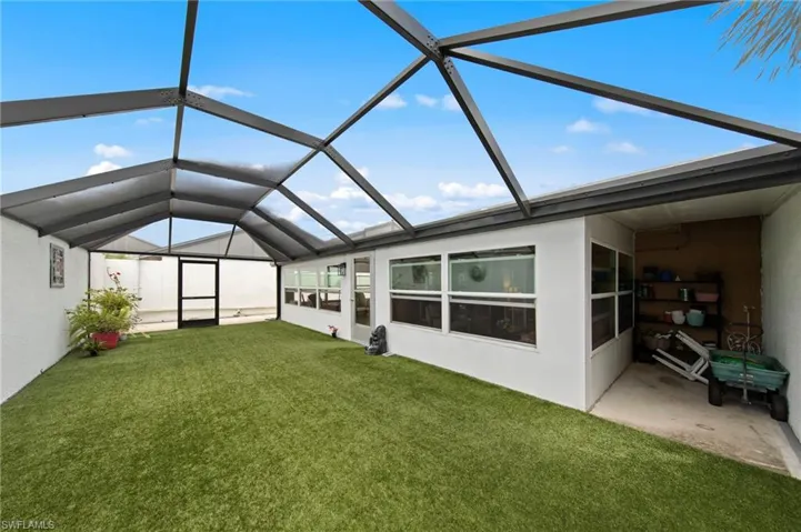 Huge 35’ x 15’ screened lanai installed in 2023, complete with newly installed astroturf for low-maintenance enjoyment, a bonus storage cove, and plenty of room to relax or entertain.