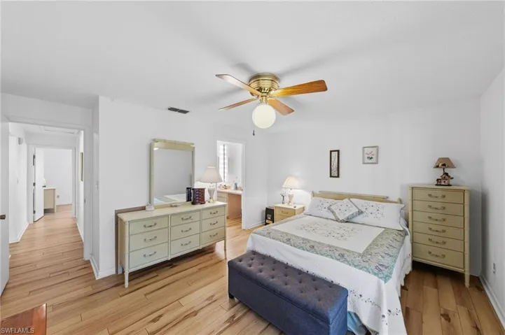 Master bedroom with ensuite bathroom and sliders that access the wrap around Florida room.