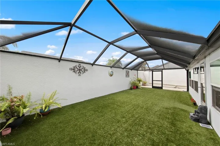 Huge 35’ x 15’ screened lanai installed in 2023, complete with newly installed astroturf for low-maintenance enjoyment, a bonus storage cove, and plenty of room to relax or entertain.