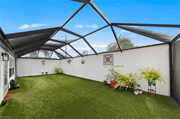 Huge 35’ x 15’ screened lanai installed in 2023, complete with newly installed astroturf for low-maintenance enjoyment, a bonus storage cove, and plenty of room to relax or entertain.