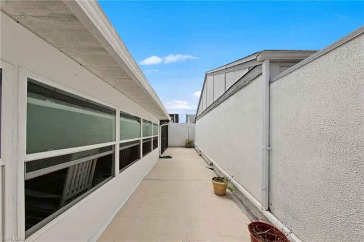 The private backyard is fully enclosed with a courtyard-style privacy wall and features southern rear exposure for ideal sunlight throughout the day.