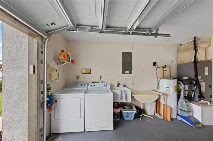 Garage with utility wash tub and washer and dryer included.