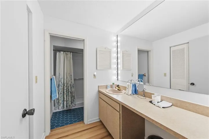 Master bathroom with make up vanity, new toilet and custom installed walk in shower.
