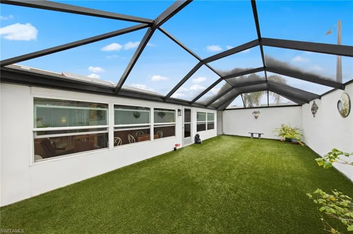 Huge 35’ x 15’ screened lanai installed in 2023, complete with newly installed astroturf for low-maintenance enjoyment, a bonus storage cove, and plenty of room to relax or entertain.