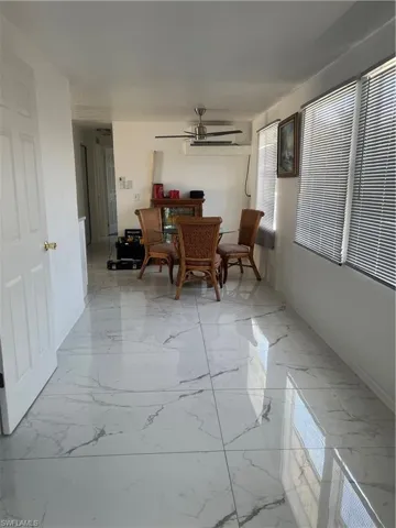 Dining area featuring marble finish floor, baseboards, and ceiling fan