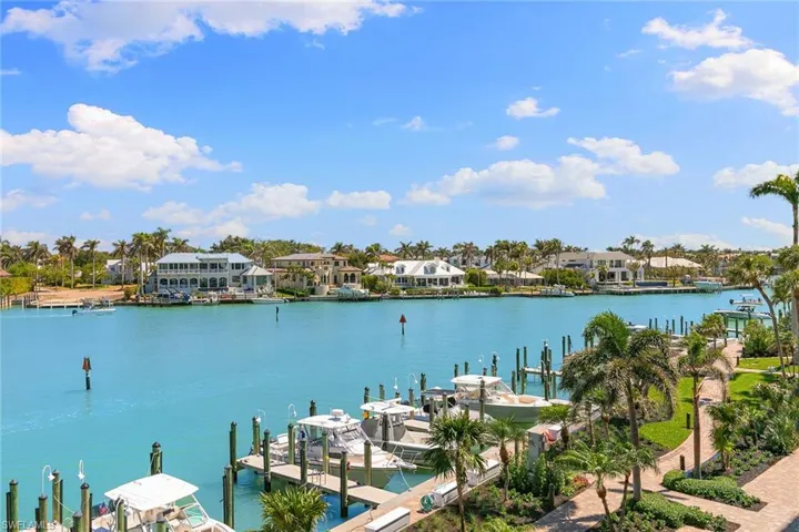 Dock featuring a water view, boat lift, and a residential view
