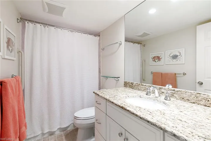 Full bath with a shower with curtain, vanity, and recessed lighting