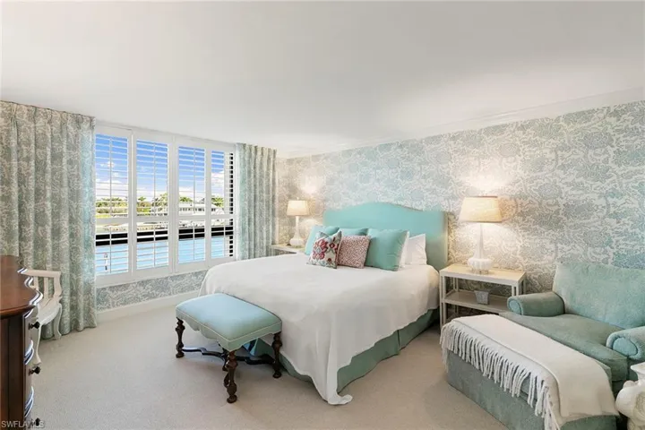 Bedroom with wallpapered walls and carpet flooring