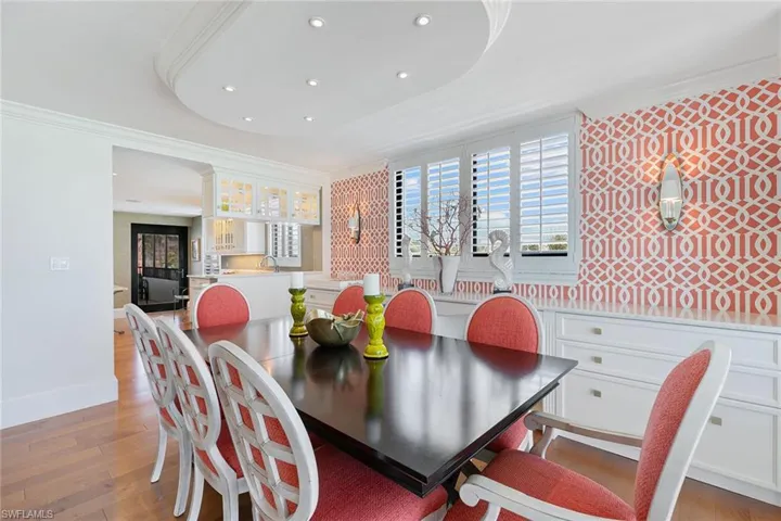 Dining space featuring crown molding, light wood-style flooring, and recessed lighting