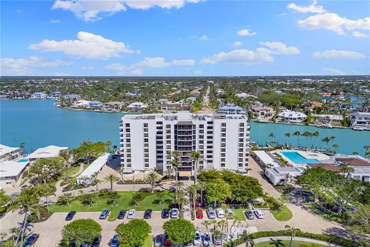Drone / aerial view of a large body of water and apartment complex / building