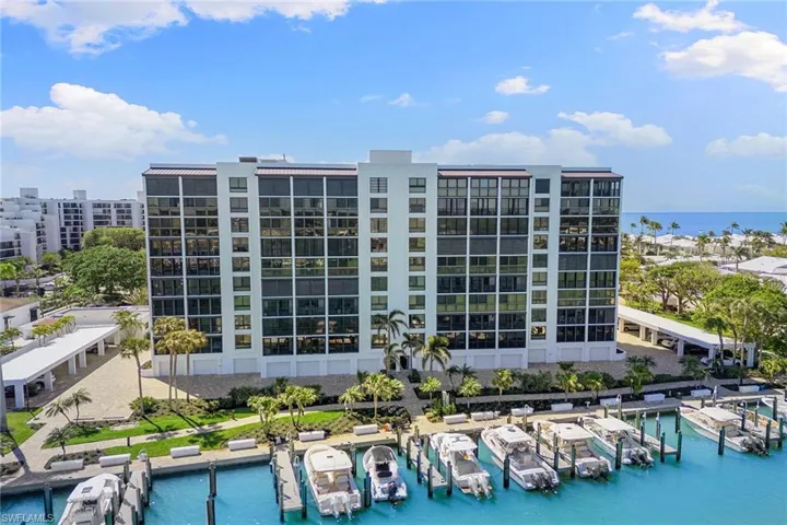 View of apartment building / complex featuring a water view and view of marina