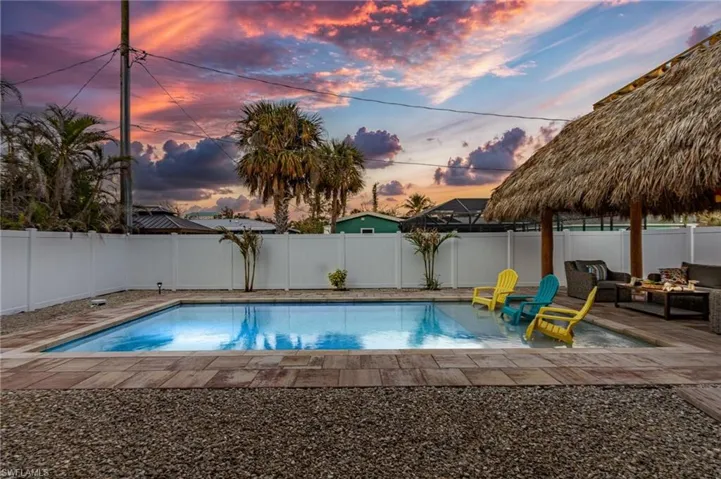 Pool at dusk with a patio area
