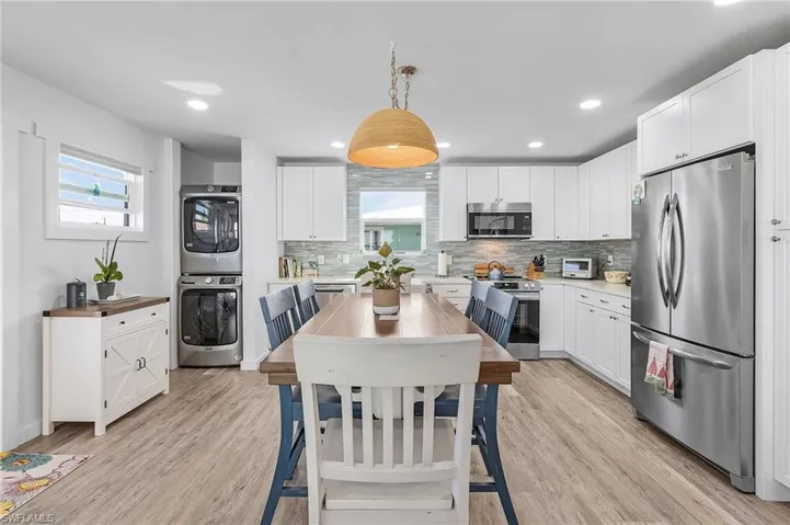 Kitchen with pendant lighting, stainless steel appliances and large aggressive space for any sized kitchen table.