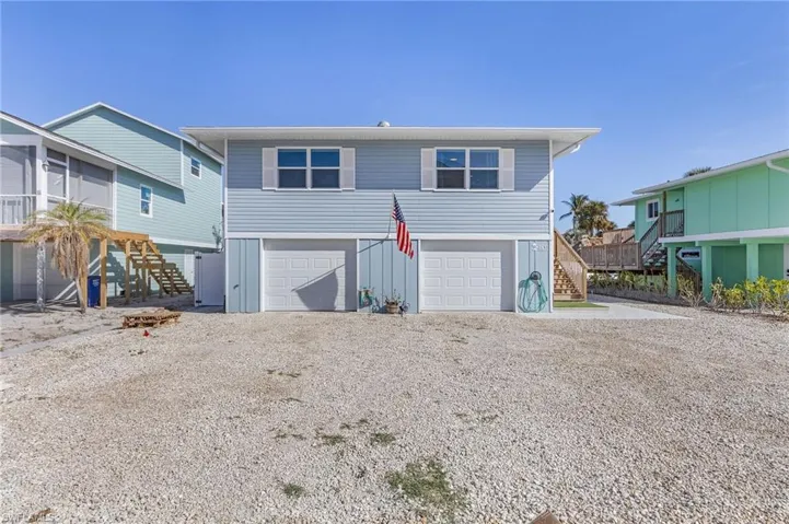 View of front of property featuring a two bay garage.