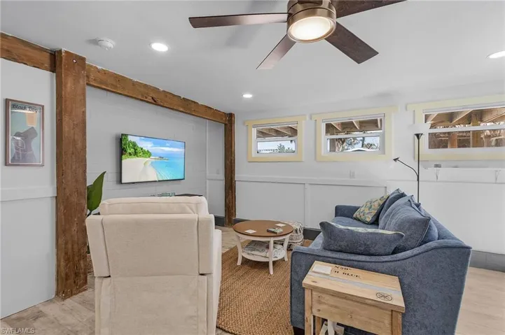 Guest quarters living room featuring ceiling fan and plenty of natural sunlight.